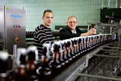 Flasche voll? Torhüter Jaroslav Drobny (links) vom VfL Bochum lässt sich von Braumeister Gerhard Schröder die Abfüllanlagen der Fiege-Brauerei genau erklären. Foto: Lichtblick
